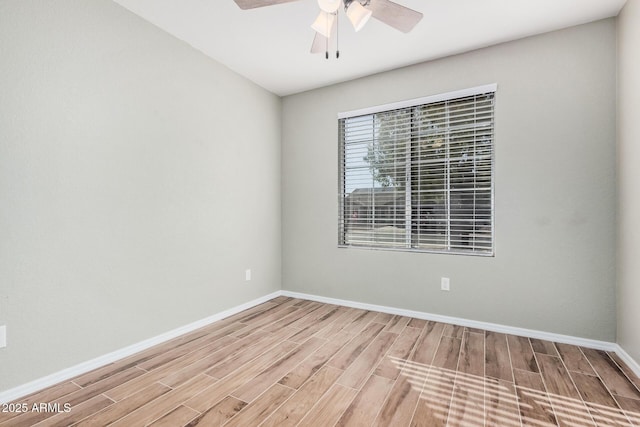 empty room with hardwood / wood-style flooring and ceiling fan