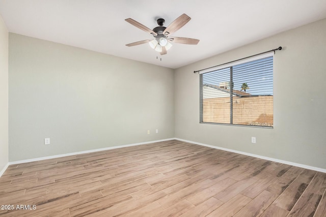 empty room with ceiling fan and light hardwood / wood-style floors