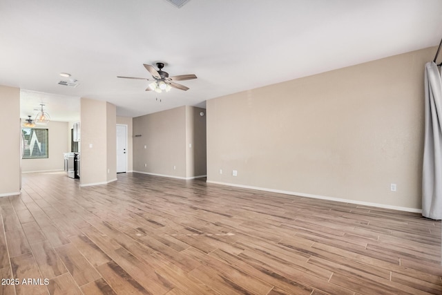 unfurnished living room featuring ceiling fan and light wood-type flooring