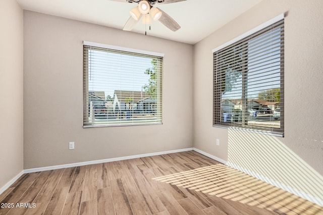 spare room with light hardwood / wood-style floors and ceiling fan