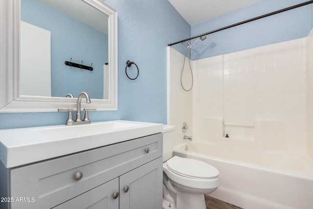 full bathroom with shower / tub combination, vanity, and toilet