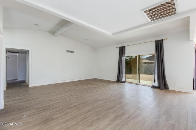 unfurnished room with baseboards, visible vents, and wood finished floors