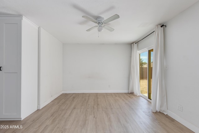 spare room with light wood-style floors, ceiling fan, and baseboards