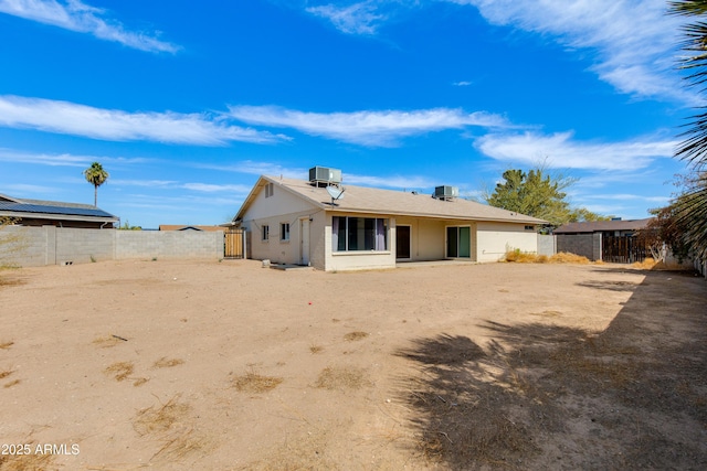 rear view of property with a fenced backyard