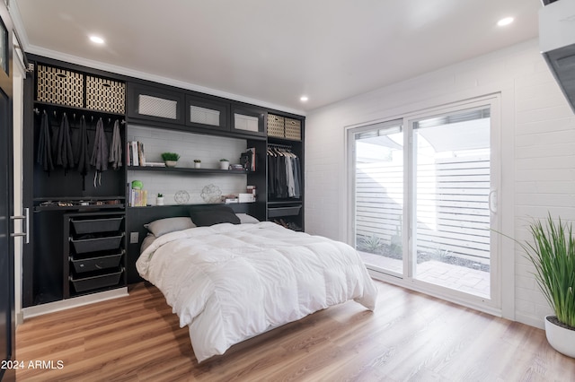 bedroom featuring access to exterior and wood-type flooring