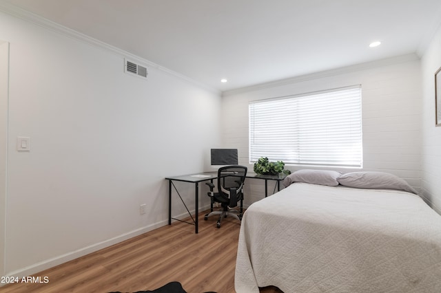 bedroom featuring hardwood / wood-style floors and ornamental molding