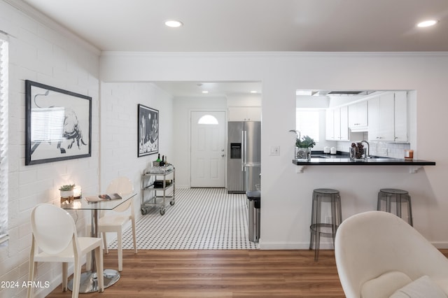 interior space with wood-type flooring and crown molding