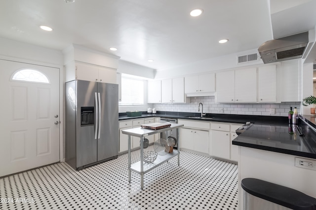 kitchen with backsplash, stainless steel appliances, white cabinetry, and sink