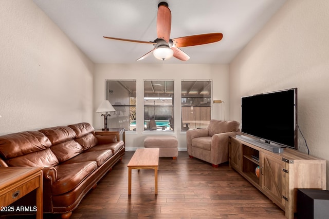 living room with ceiling fan and dark hardwood / wood-style flooring