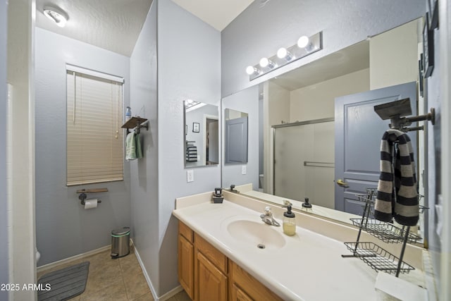 full bathroom with tile patterned flooring, baseboards, toilet, an enclosed shower, and vanity