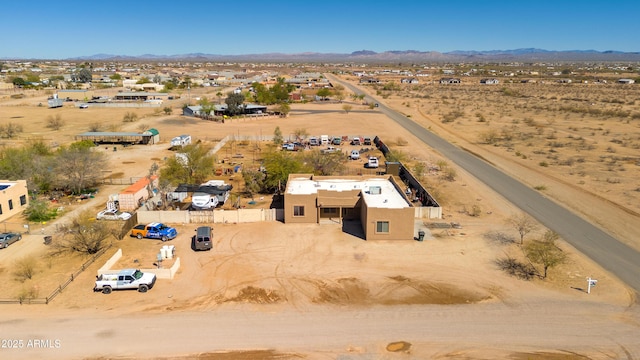 birds eye view of property with view of desert and a mountain view