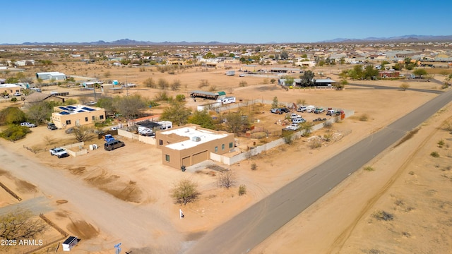 drone / aerial view with view of desert and a mountain view