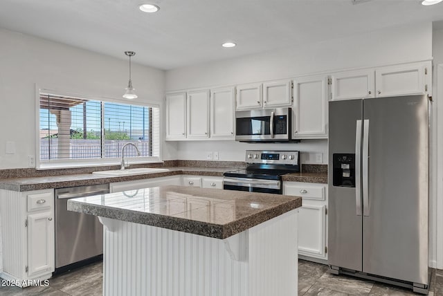1160 E Hampton Cir, Mesa, AZ 85204 - kitchen with appliances with stainless steel finishes, tile counters, white cabinetry, decorative light fixtures, and recessed lighting