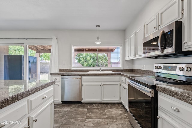 1160 E Hampton Cir, Mesa, AZ 85204 - kitchen featuring appliances with stainless steel finishes, plenty of natural light, white cabinets, and pendant lighting