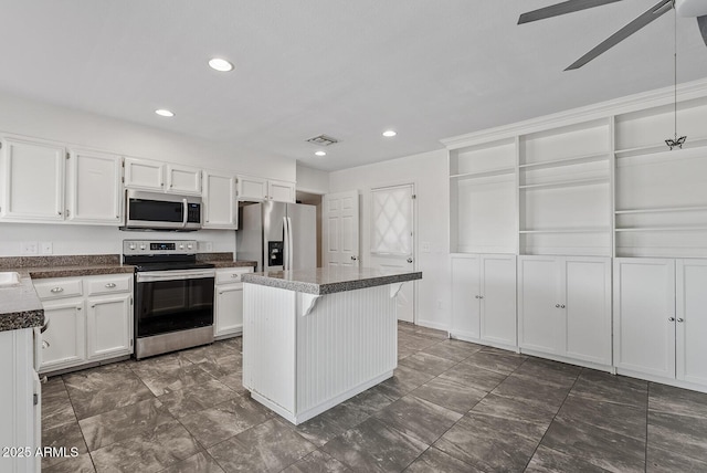 1160 E Hampton Cir, Mesa, AZ 85204 - kitchen with appliances with stainless steel finishes, ceiling fan, white cabinets, dark countertops, and recessed lighting