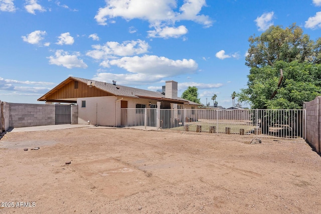 1160 E Hampton Cir, Mesa, AZ 85204 - back of house with brick siding, a chimney, a gate, and an attached carport