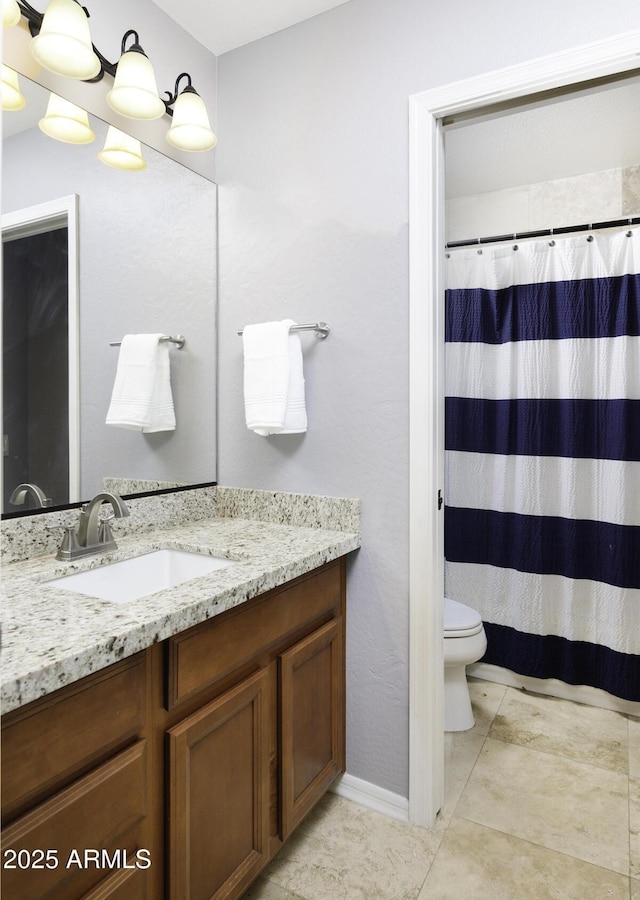 bathroom featuring walk in shower, vanity, toilet, and tile patterned flooring