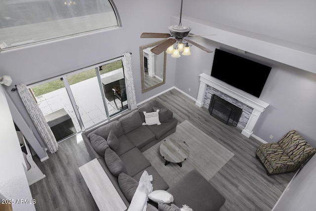 living room with dark hardwood / wood-style floors and ceiling fan