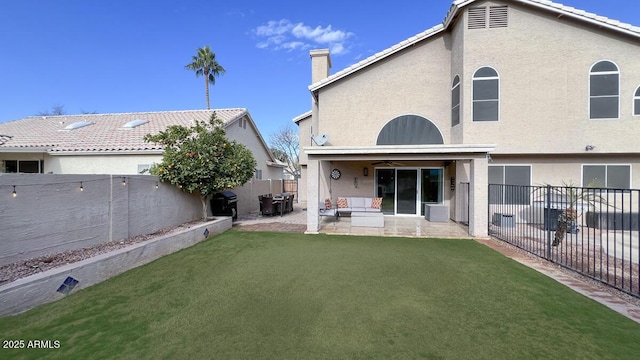 back of house featuring a patio and a lawn