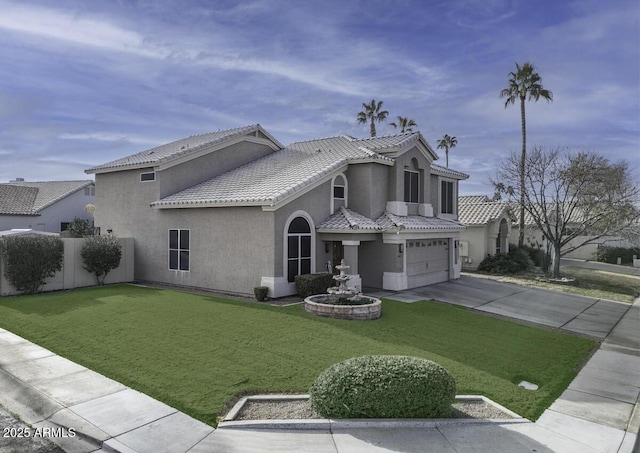 mediterranean / spanish home featuring a garage and a front lawn