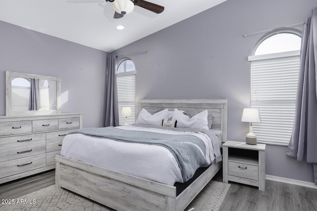 bedroom with lofted ceiling, dark wood-type flooring, and ceiling fan