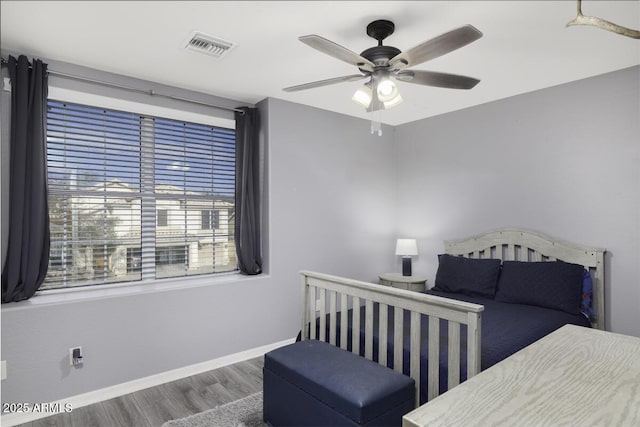 bedroom with ceiling fan and wood-type flooring