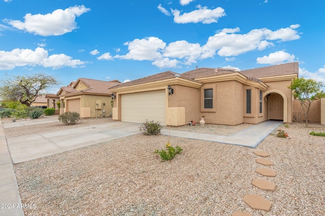 17572 W Dalea Dr, Goodyear, AZ 85338 - view of front of home featuring stucco siding, a tile roof, driveway, and an attached garage