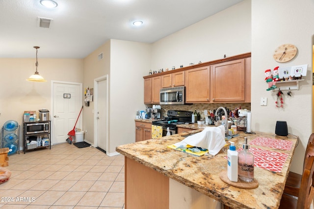 kitchen with electric range, light stone countertops, pendant lighting, decorative backsplash, and light tile patterned flooring