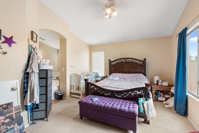 carpeted bedroom with vaulted ceiling