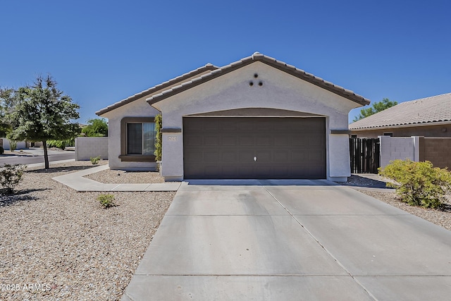 16523 W Desert Bloom St, Goodyear, AZ 85338 - view of front facade featuring stucco siding, concrete driveway, a garage, and a tile roof