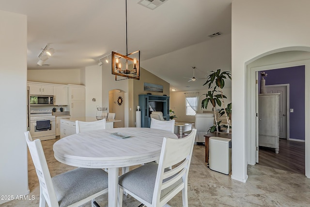 16523 W Desert Bloom St, Goodyear, AZ 85338 - dining area with arched walkways, lofted ceiling, track lighting, a chandelier, and a ceiling fan