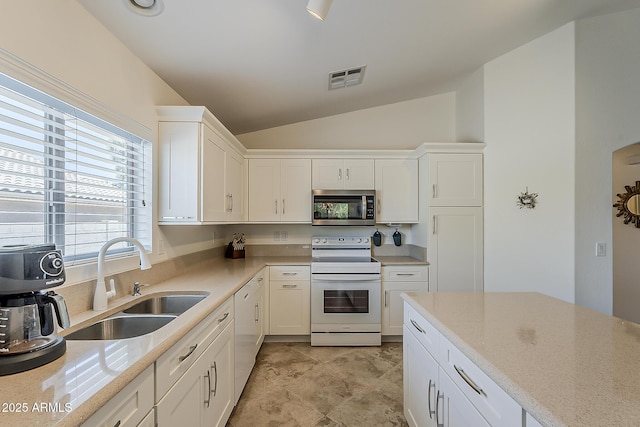 16523 W Desert Bloom St, Goodyear, AZ 85338 - kitchen featuring white appliances, vaulted ceiling, and white cabinetry