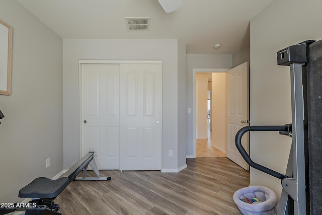 16523 W Desert Bloom St, Goodyear, AZ 85338 - workout room with wood finished floors and baseboards
