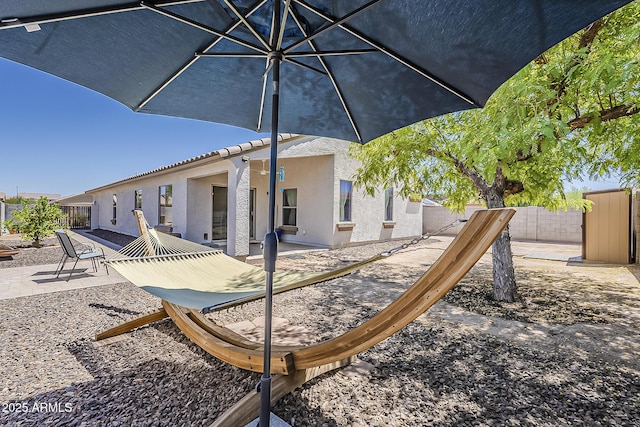 16523 W Desert Bloom St, Goodyear, AZ 85338 - rear view of property featuring a fenced backyard, a patio, and stucco siding
