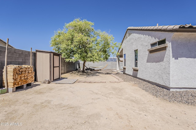 16523 W Desert Bloom St, Goodyear, AZ 85338 - view of home's exterior featuring a storage unit and stucco siding