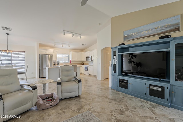 16523 W Desert Bloom St, Goodyear, AZ 85338 - living room featuring vaulted ceiling, rail lighting, and a ceiling fan