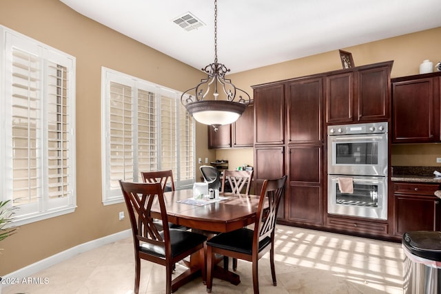 dining space featuring light tile patterned floors