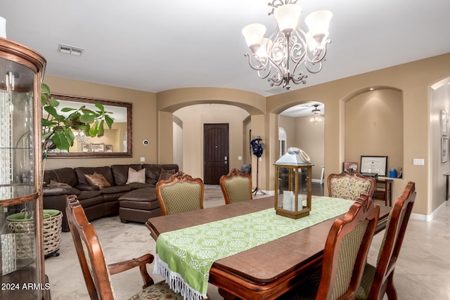 dining space with ceiling fan with notable chandelier and light tile patterned flooring