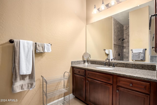 bathroom featuring vanity and tiled shower