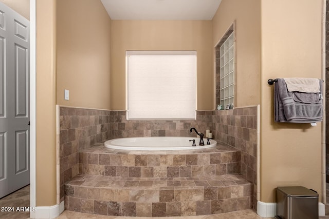 bathroom featuring tiled tub