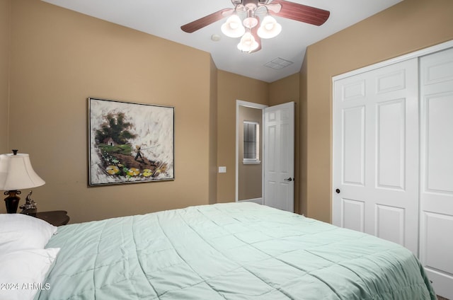 bedroom featuring ceiling fan and a closet