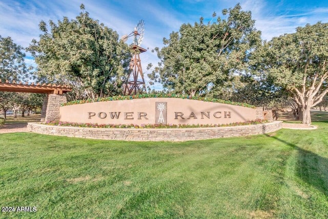 community / neighborhood sign with a lawn