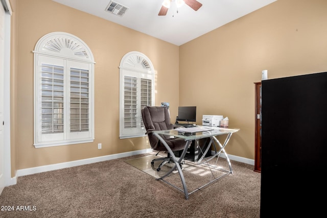 carpeted home office with ceiling fan and vaulted ceiling