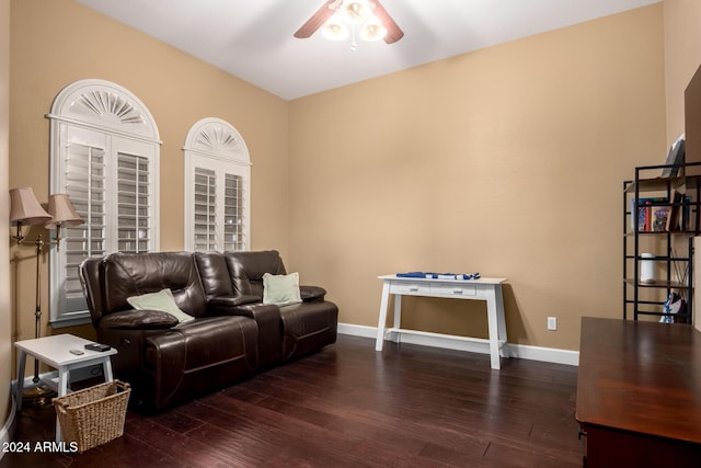 living room with ceiling fan and dark wood-type flooring