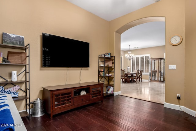 living room featuring dark hardwood / wood-style floors and an inviting chandelier