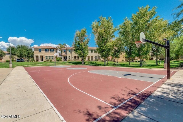 view of sport court with a lawn