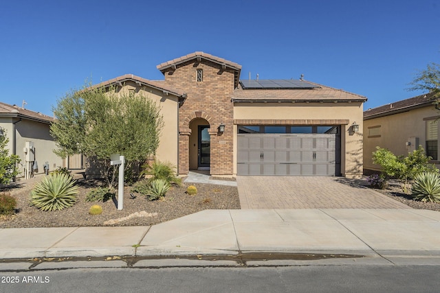 view of front of house with a garage and solar panels