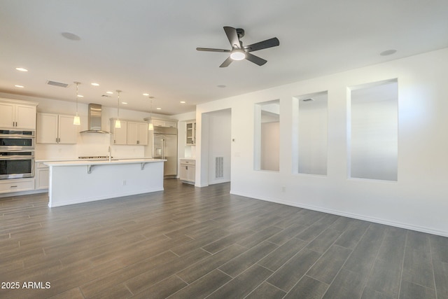 unfurnished living room featuring dark hardwood / wood-style floors and ceiling fan