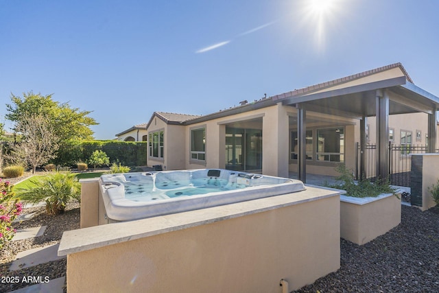 view of pool with a hot tub