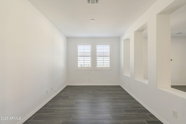 spare room featuring dark hardwood / wood-style floors